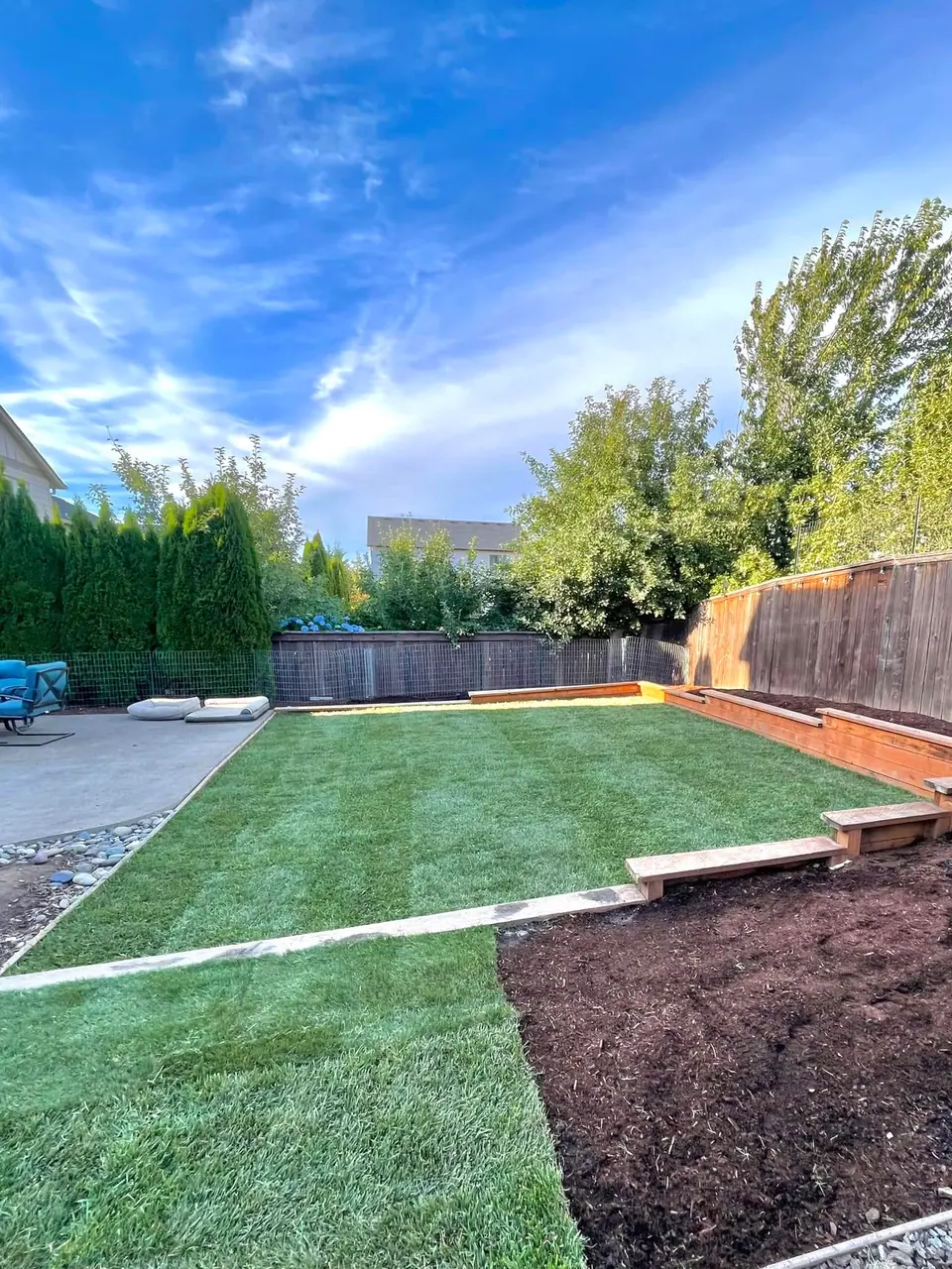 Artificial turf lawn built above a block retaining wall