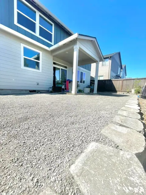 Concrete walkway poured along the side of a home