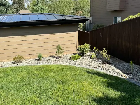 Gravel bed and low shrubs bordering a home foundation