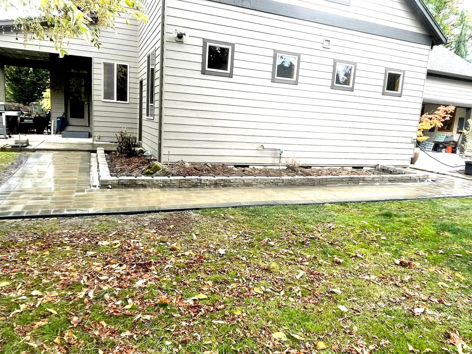 New lawn installed across a large backyard behind a covered patio