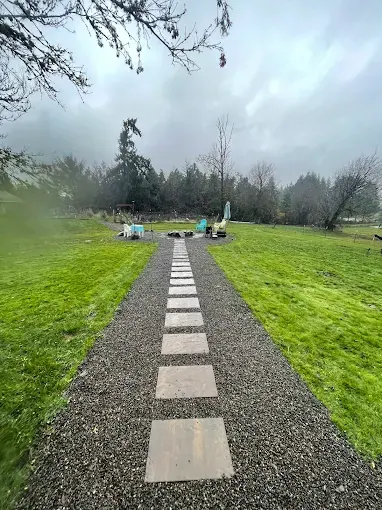 Stepping stone path crossing a wide open lawn